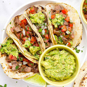 Nut-free lunch plate with beef tacos, fresh salsa, guacamole and lime, allergy-friendly meal