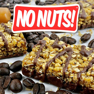 Nut-free snack bars with chocolate drizzle, surrounded by coffee beans, No Nuts branding visible.