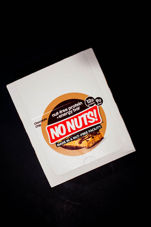 No Nuts nut-free chocolate chip protein energy bar box on a black background.