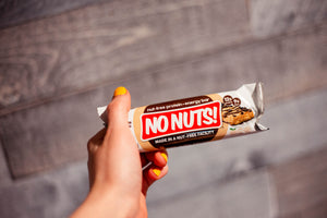 Hand holding No Nuts! nut-free snack bar, allergy-friendly protein bar packaging
