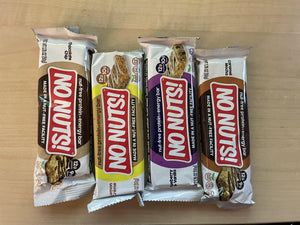 No Nuts nut-free snack bars assorted flavors on wooden table, allergy-friendly packaging