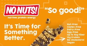 No Nuts nut-free snack bar with chocolate chips on orange background, highlighting nut-free, gluten-free, vegan, school-safe features.