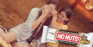 Smiling sisters outdoors with No Nuts nut-free snack bar, allergy-friendly and school-safe