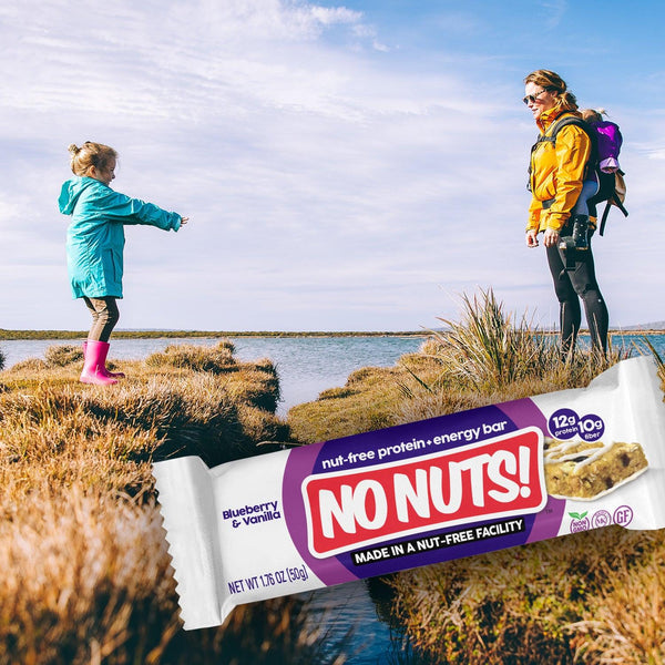 No Nuts! Blueberry Vanilla nut-free protein bar outdoors with child and adult hiking by water