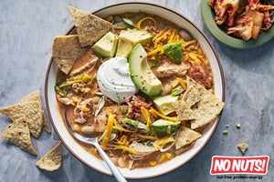 Nut-free chicken soup with avocado, tortilla chips, shredded cheese, and No Nuts! logo