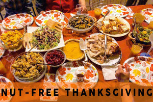 Nut-free Thanksgiving dinner with colorful fall-themed plates, turkey, pie, and side dishes.