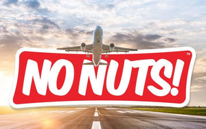 Airplane taking off with No Nuts! nut-free snack bars logo on runway, allergy-friendly travel